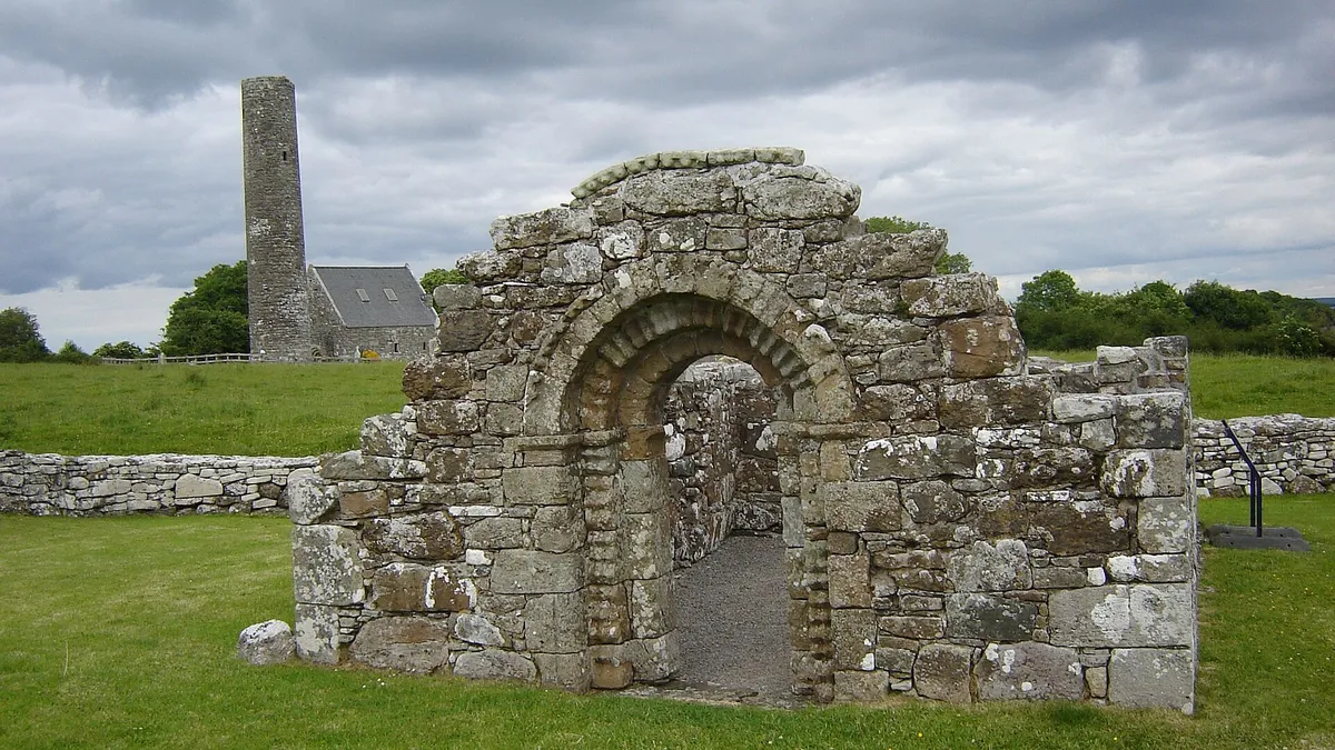 The Romanesque doorway of St Brigid's church on Holy Island, with the round tower behind