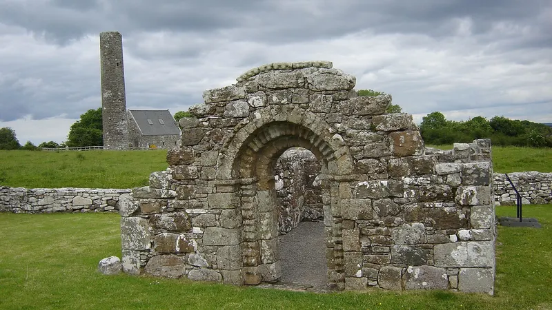 The Romanesque doorway of St Brigid's church on Holy Island, with the round tower behind