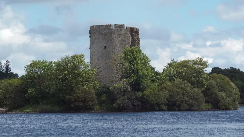The round keep of Clogh Oughter Castle on its wooded island in Lough Oughter