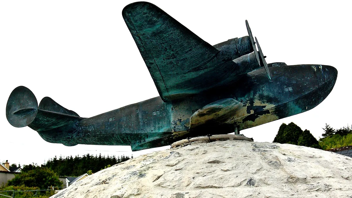 A bronze flying boat mounted on a stone plinth outside the museum at Foynes