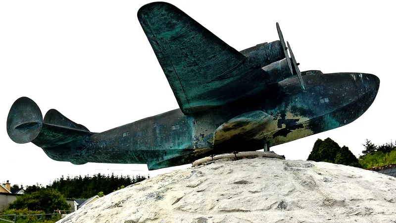 A bronze flying boat mounted on a stone plinth outside the museum at Foynes
