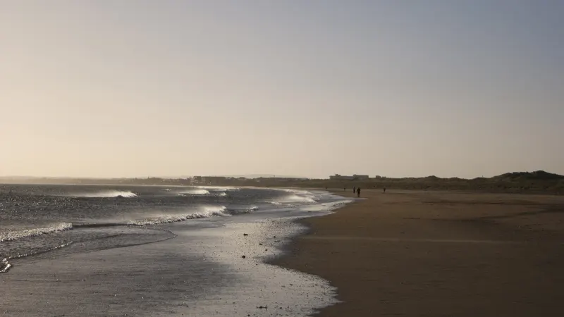 The long flat beach at Laytown at dusk with the tide out