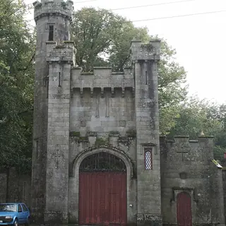 The castellated stone entrance archway at Borris House with its red painted door