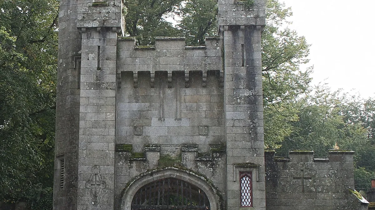 The castellated stone entrance archway at Borris House with its red painted door