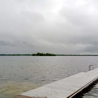 A timber jetty running out into Lough Owel under a grey sky