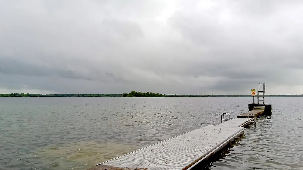 A timber jetty running out into Lough Owel under a grey sky