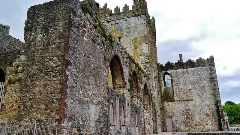 The stone ruins and arched windows of Tintern Abbey, County Wexford