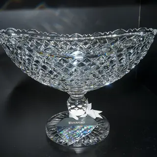 A cut crystal bowl lit against a dark background at the House of Waterford Crystal