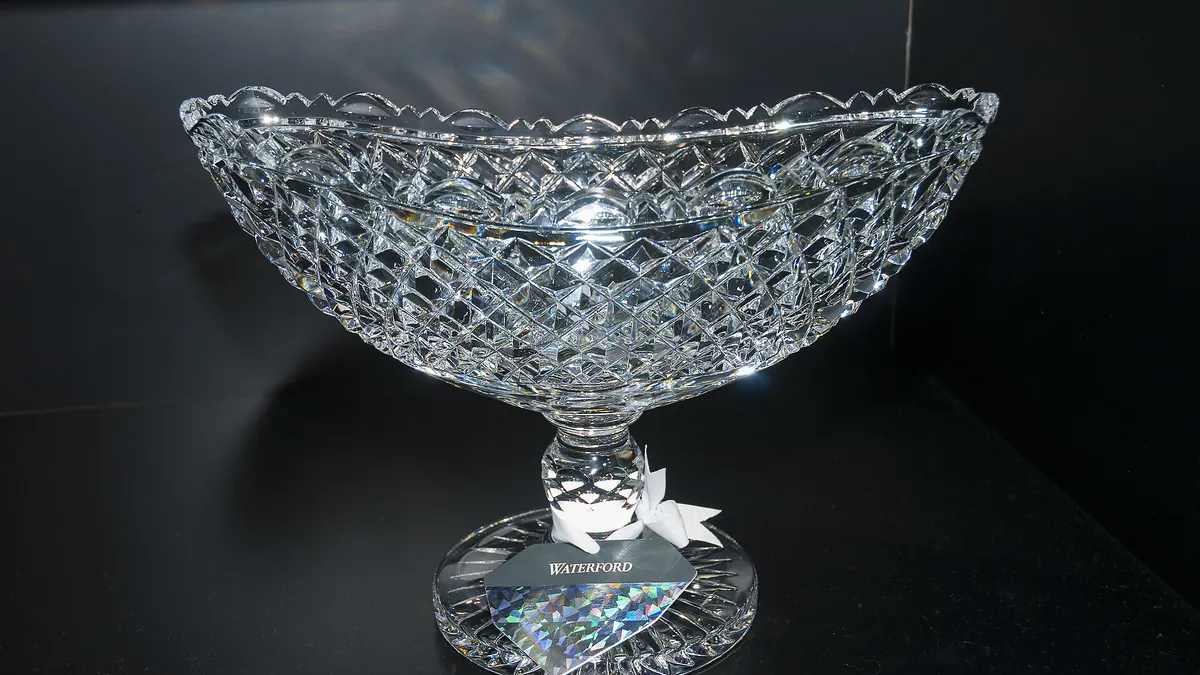 A cut crystal bowl lit against a dark background at the House of Waterford Crystal