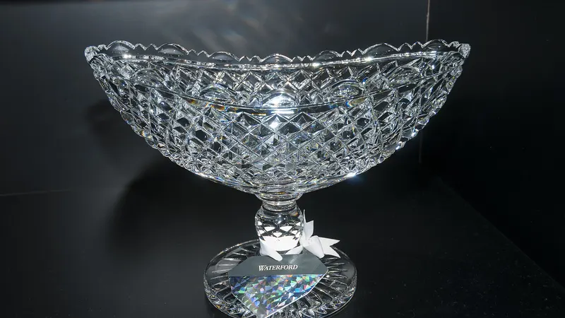 A cut crystal bowl lit against a dark background at the House of Waterford Crystal